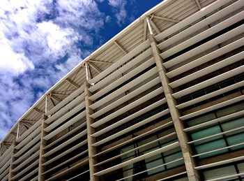 Low angle view of office building against blue sky