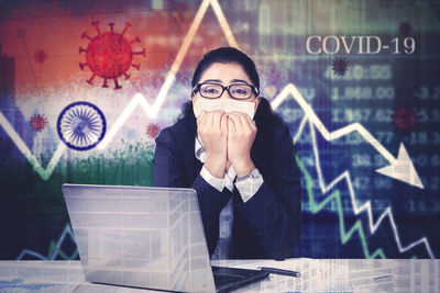 Portrait of young woman sitting on table