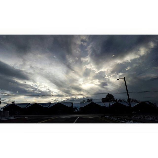 sky, low angle view, built structure, silhouette, cloud - sky, architecture, building exterior, transfer print, cloudy, cloud, auto post production filter, power line, connection, street light, dusk, outdoors, no people, overcast, electricity pylon, electricity