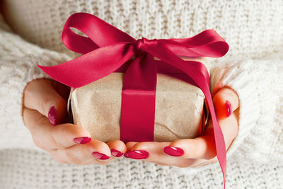 Cropped hand of woman holding gift