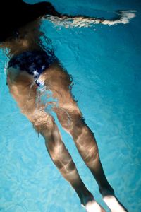 Low section of woman swimming in pool