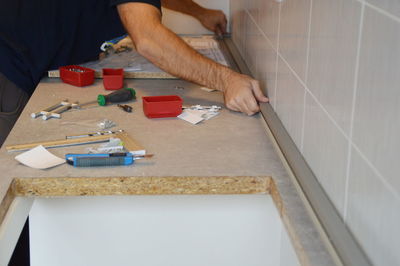 Close-up of craftsperson working on table