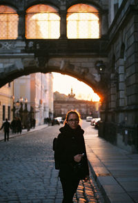 Portrait of smiling woman standing in city