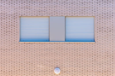 Closed window on brick wall of building