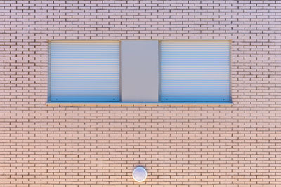 Closed window on brick wall of building