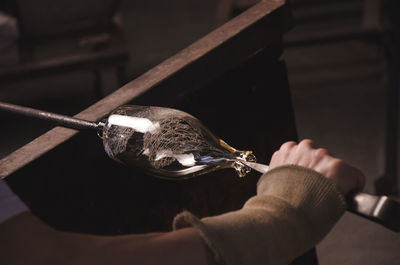 Close-up of person making glassware