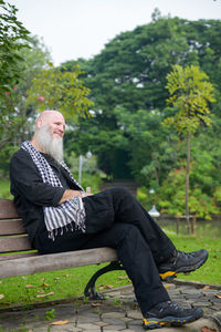 Man sitting on bench in park