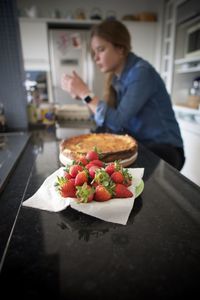 Woman holding fruits on table