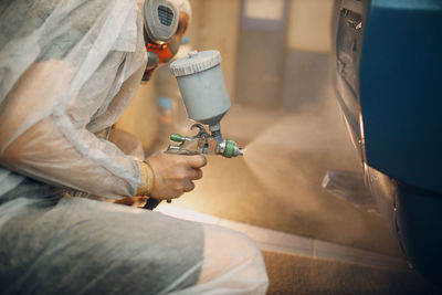 Midsection of man cleaning car