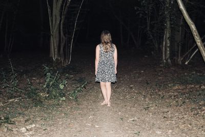 Girl walking through a woodland