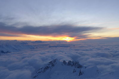 Scenic view of snowcapped mountains against sky during sunset