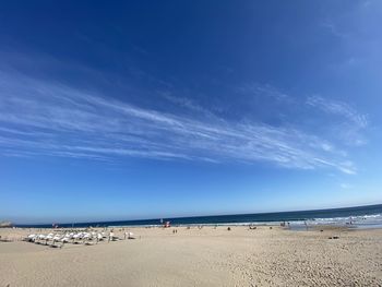 Scenic view of beach against blue sky