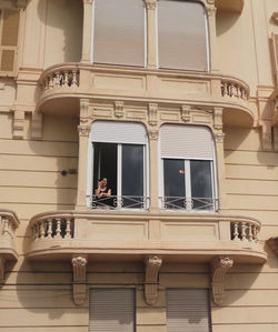 Low angle view of people standing outside building