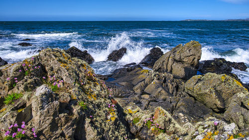 Panoramic view of rocks on beach against sky