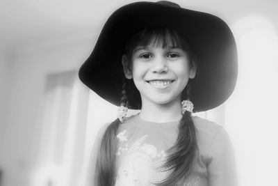 Portrait of smiling girl wearing hat at home