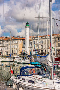 Sailboats moored in harbor