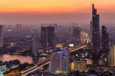 High angle view of illuminated buildings in city against sky