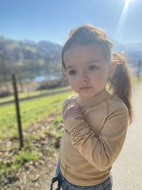 Portrait of girl standing on field