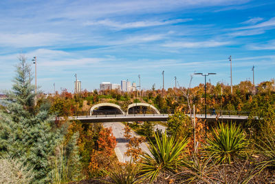 Built structure by plants against sky