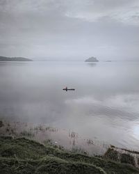 Fisherman with his raft to the middle of the lake to look for fish