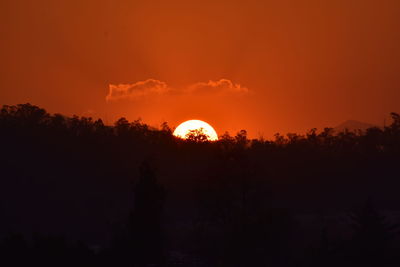 Silhouette trees against sky during sunset