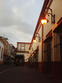 Empty road along buildings