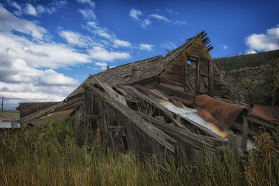 Low angle view of built structure on field against sky