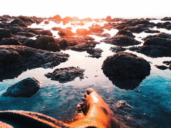 Scenic view of rocks in sea against sky