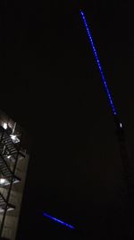 Close-up of illuminated lighting equipment against black background