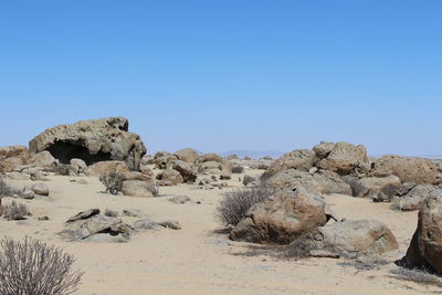 Rock formations in desert against clear blue sky