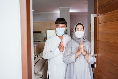 Portrait of friends standing at home