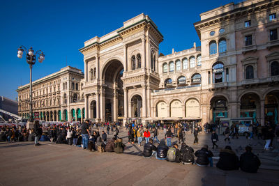 People at piazza duomo, famous place and landmark in milan city, italy in a clear blue sky day.