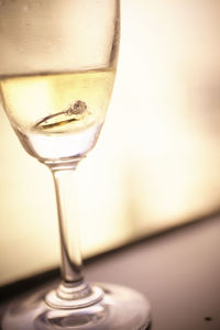 Close-up of ring in champagne flute
