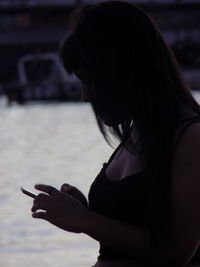 Side view of woman using smart phone