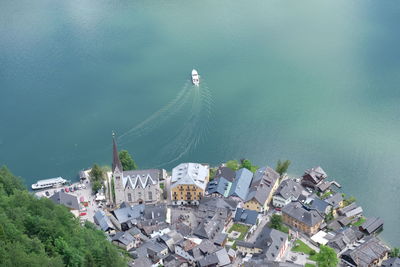 High angle view of boat moving by townscape