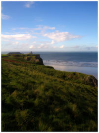 Scenic view of sea against cloudy sky