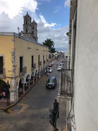 View of city street and buildings against sky