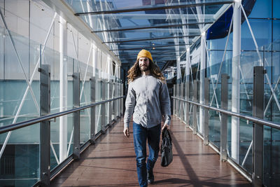 Full length of woman standing on railing