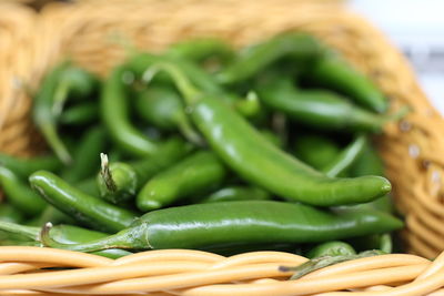 Close-up of green chili peppers in basket