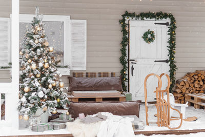 The porch of a country house decorated for christmas and new year holidays. christmas tree