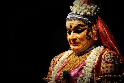 Close-up of statue against black background