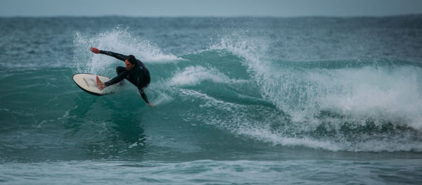 People surfing in sea