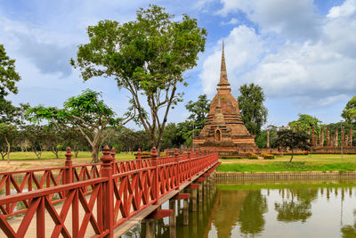 Panoramic view of temple amidst trees and building against sky