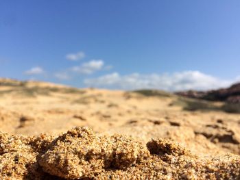 Close-up of sand dune in desert against sky