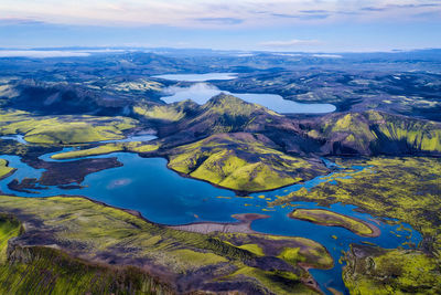 Aerial view of landscape against cloudy sky