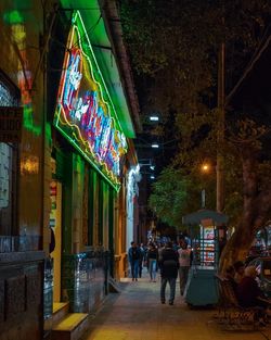 People in illuminated building at night