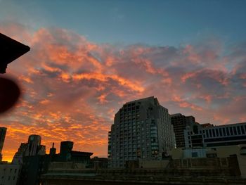 Low angle view of cityscape against sky during sunset