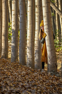 Low section of woman standing in forest