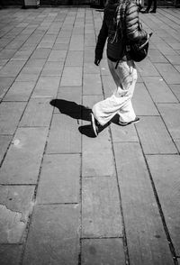 Low section of woman walking on street