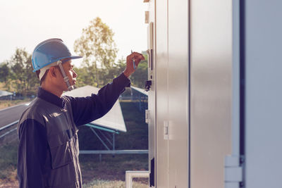 Male engineer checking meter